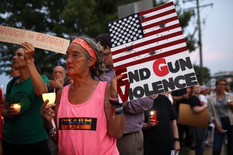 Sandi Lisko attends a vigil for recent victims of gun violence outside the National Rifle Association's headquarters building, Monday, Aug. 5, 2019, in Fairfax, Va. (AP Photo/Patrick Semansky)