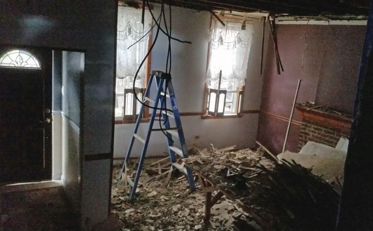 Removing plaster from the ceiling involves yanking it down onto your head, until you are calf-deep in broken plaster. (Peter Crimmins/WHYY)