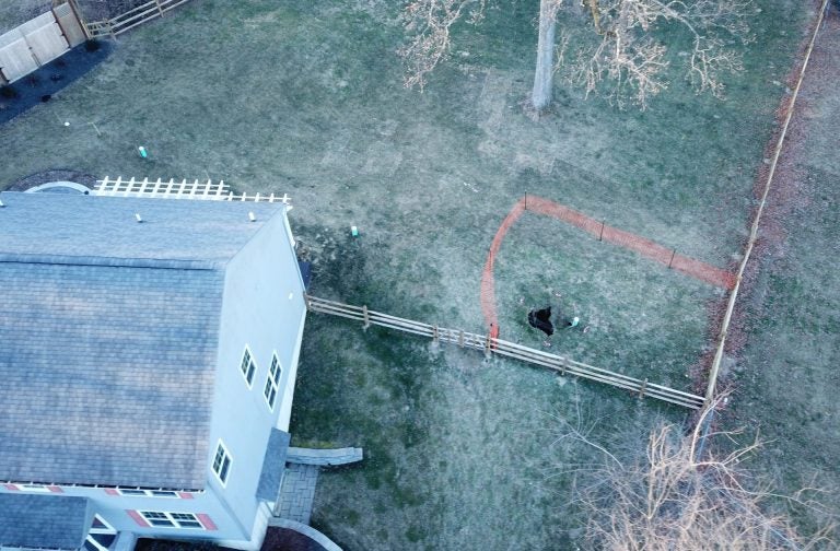 A sinkhole that opened up in January was surrounded by orange plastic fencing outside a suburban home at Lisa Drive in West Whiteland Township, Chester County. (Courtesy of Eric Friedman) 