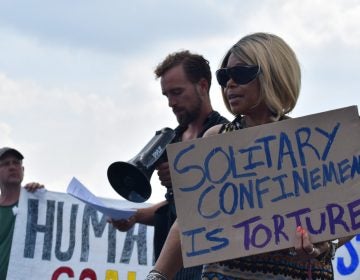 Members of the group Human Rights Coalition speak at a rally Friday, Aug. 2, 2019 at Department of Corrections headquarters in Mechanicsburg, Cumberland County. (Brett Sholtis/WITF)