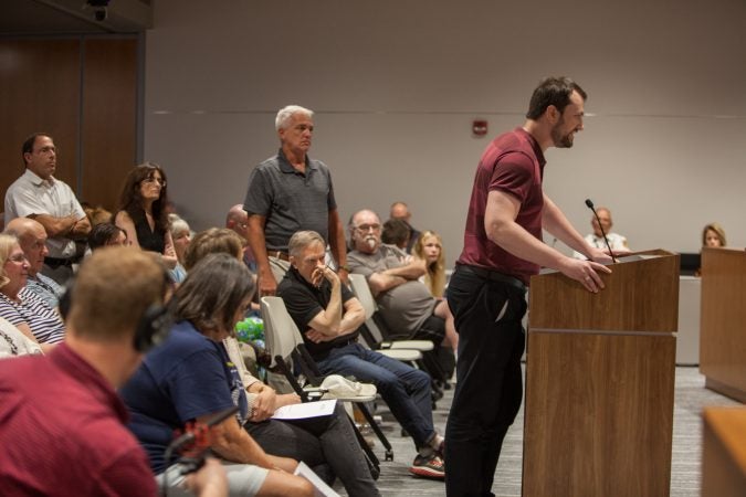 Justin Menga, a resident of the 6th ward, speaks out against the townships decision to close the Bon Air fire company. (Emily Cohen for WHYY)