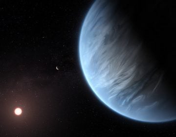 This artist's impression shows the planet K2-18b, its host star and an accompanying planet in this system. By ESA/Hubble, M. Kornmesser 