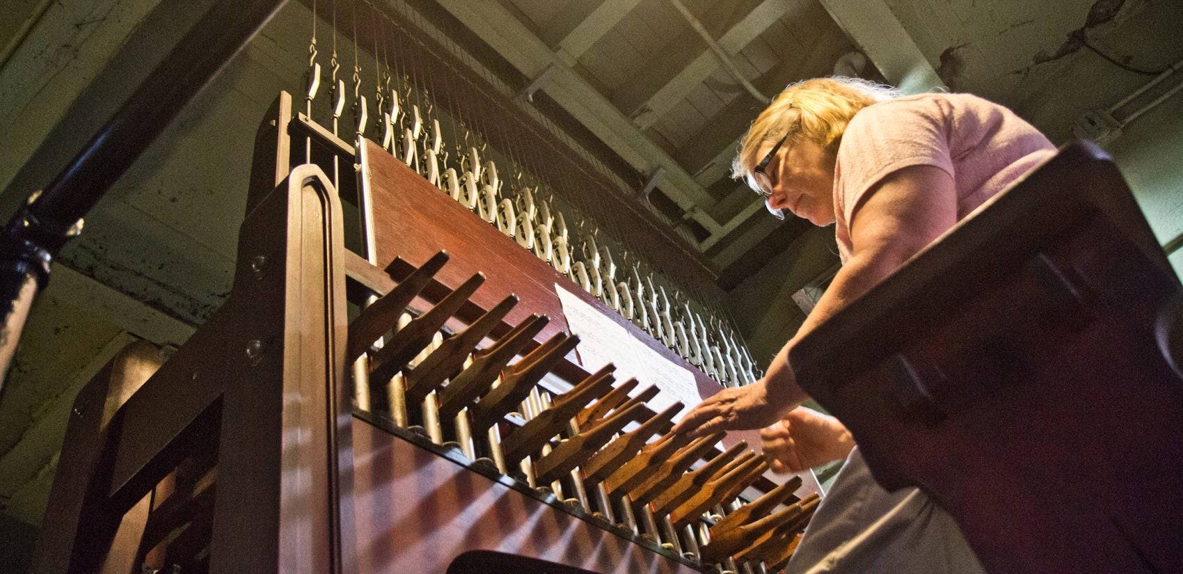 Janet Tebbel plays the carillon beneath the attached bells at the Miraculous Medal Shrine. (Kimberly Paynter/WHYY)