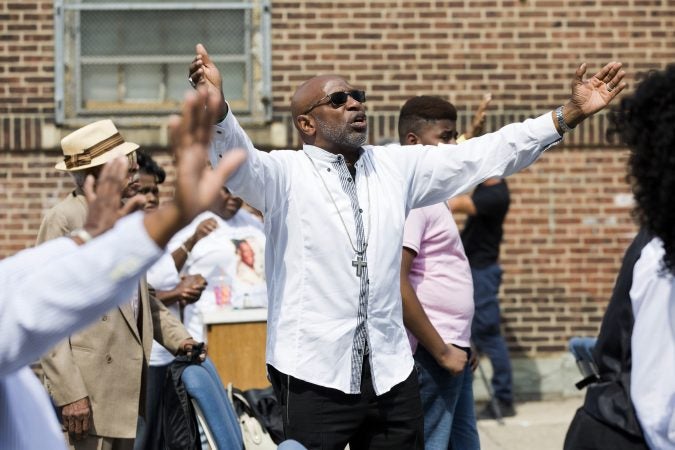 Bishop Benjamin Peterson Jr. (center) walks into the crowd as he leads Sunday morning services at Greater Bible Way Temple on Sept. 1, 2019. (Rachel Wisniewski for WHYY)