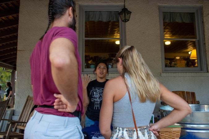 A Whitesbog volunteer interacts with guests at the 