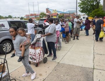 People queue up during a food giveaway at Dobbins High School in North Philadelphia this summer. (Avi Steinhardt/The Philadelphia Inquirer)