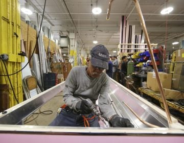 In this Thursday, Oct. 18, 2018, photo Luis Ramos works at the Howard McCray's commercial refrigeration manufacturing facility in Philadelphia. (Matt Rourke/AP Photo)