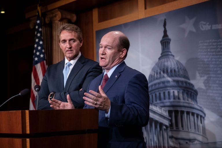 Sen. Jeff Flake, R-Ariz., left, and Sen. Chris Coons, D-Del., speak to reporters about their effort to bring up legislation to protect special counsel Robert Mueller, at the Capitol in Washington, Wednesday, Nov. 14, 2018.  (AP Photo/J. Scott Applewhite)