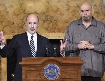 Pennsylvania Gov. Tom Wolf (left) and Lt. Gov. John Fetterman stand at a podium