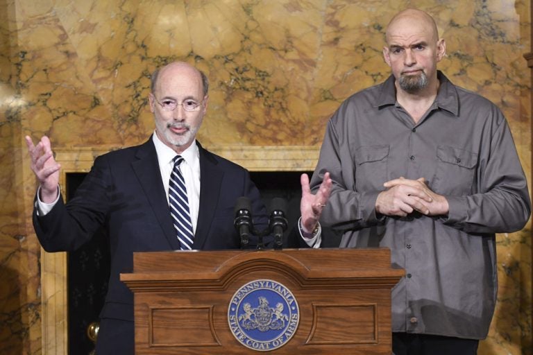 Pennsylvania Gov. Tom Wolf (left) and Lt. Gov. John Fetterman stand at a podium