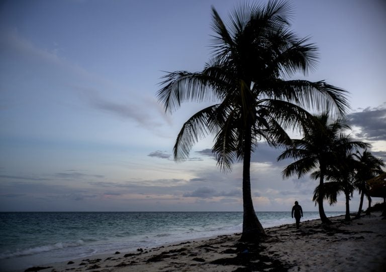 A woman walks along a beach before the arrival of Hurricane Dorian in Freeport, Grand Bahama, Bahamas, Saturday Aug. 31, 2019. Hurricane Dorian is closing in on the northern Bahamas, threatening to batter the normally idyllic islands with fierce winds, pounding waves and torrential rain. (Ramon Espinosa/AP Photo)