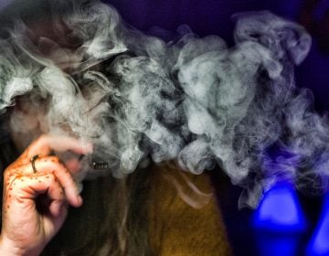 A woman takes a puff from a cannabis vape pen in Los Angeles. (Richard Vogel/AP Photo)