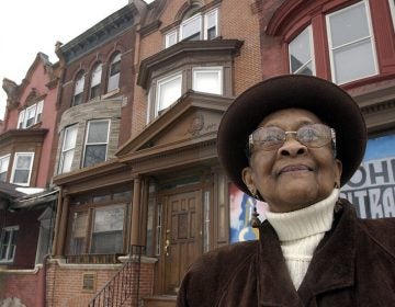 This 2003 photo shows Mary Alexander, John Coltrane's cousin, in front of the John Coltrane house in Philadelphia. Jazz giant John Coltrane’s cousin, who inspired the composition “Cousin Mary” from his landmark album “Giant Steps,” has died in Philadelphia. Mary Lyerly Alexander was 92. Carla Washington of Philadelphia’s Clef Club who is a friend of the family says Alexander died Aug. 31, 2019. (Akira Suwa/The Philadelphia Inquirer via AP)