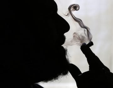 In this Nov. 21, 2014 file photo, a man smokes medical marijuana at his home in Belfast, Maine. (Robert F. Bukaty/AP Photo)