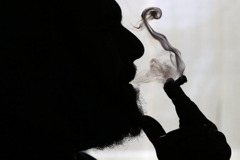 In this Nov. 21, 2014 file photo, a man smokes medical marijuana at his home in Belfast, Maine. (Robert F. Bukaty/AP Photo)