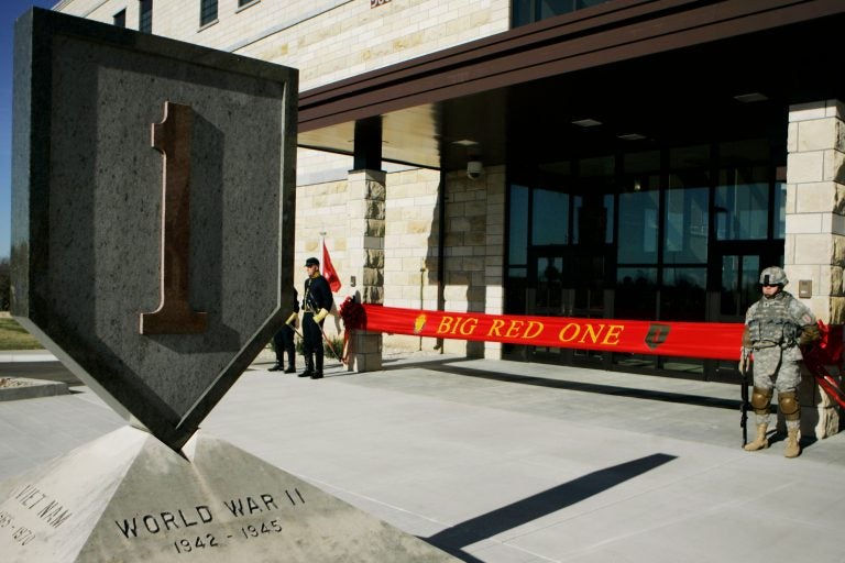 In this Feb. 9, 2015 file photo, an honor guard stands at the entrance before ribbon cutting ceremonies for the new 1st Infantry Division Headquarters at Fort Riley, Kan. Prosecutors say a U.S. Army infantry soldier stationed at Fort Riley shared bomb-making instructions online and also discussed killing activists and bombing a news network. The Justice Department says Monday, Sept. 23, 2019, that private first class Jarrett William Smith was charged with distributing information related to explosives and weapons of mass destruction. (AP Photo/Orlin Wagner File)
