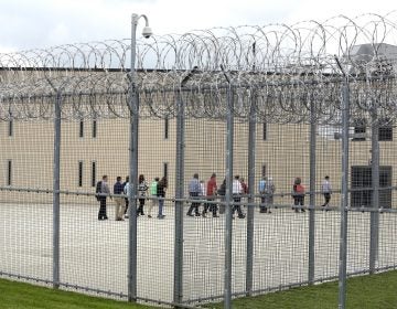 In this June 1, 2018, file photo, people walk on a tour of the West section of the State Correctional Institution at Phoenix in Collegeville, Pa. (AP Photo/Jacqueline Larma, File)