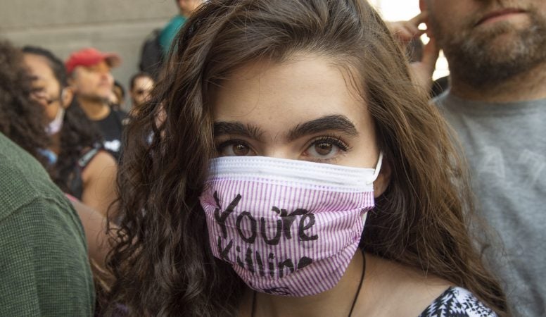 A protester wears a mask at the Philadelphia climate strike. (Jonathan Wilson for WHYY)