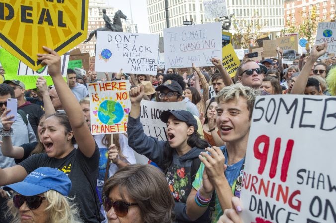 Thousands of students and their supporters cheer on speakers at the climate strike on the north side of City Hall. (Jonathan Wilson for WHYY)