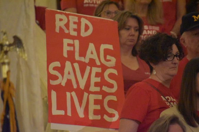 A demonstrator with the Pennsylvania chapter of Moms Demand Action holds a sign that reads 