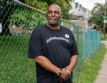 Atiba Kwesi, 59, of Overbrook in West Philadelphia poses for a portrait outside of Fellowship Christian Church wearing a shirt reading 