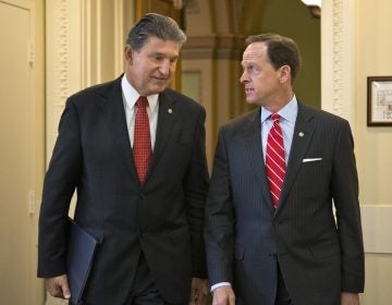 In this April 10, 2013 file photo, Sen. Joe Manchin, D-W.Va. (left) and Sen. Patrick Toomey, R-Pa. arrive for a news conference on Capitol Hill in Washington to announce that they have reached a bipartisan deal on expanding background checks to more gun buyers. (AP Photo/J. Scott Applewhite, File)