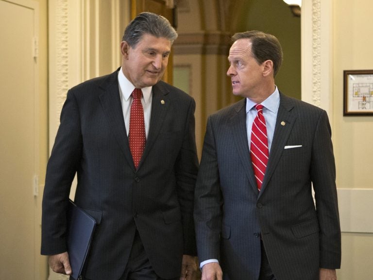 In this April 10, 2013 file photo, Sen. Joe Manchin, D-W.Va. (left) and Sen. Patrick Toomey, R-Pa. arrive for a news conference on Capitol Hill in Washington to announce that they have reached a bipartisan deal on expanding background checks to more gun buyers. (AP Photo/J. Scott Applewhite, File)