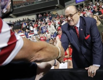 Former New York City Mayor Rudy Giuliani shook hands with supporters as he arrived at President Trump's campaign rally on Aug. 15, 2019, in Manchester, N.H. (Elise Amendola/AP)
