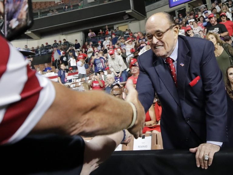 Former New York City Mayor Rudy Giuliani shook hands with supporters as he arrived at President Trump's campaign rally on Aug. 15, 2019, in Manchester, N.H. (Elise Amendola/AP)