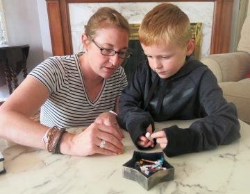 After finishing up some household chores, Brody Knapp gets a chance to play with his mother, Ashley, at their home in Kansas City, Mo. (Alex Smith/KCUR)