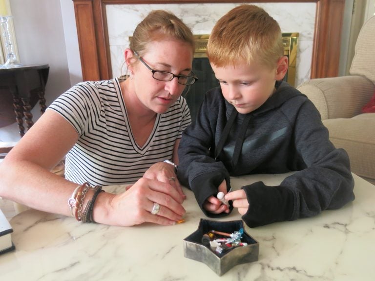 After finishing up some household chores, Brody Knapp gets a chance to play with his mother, Ashley, at their home in Kansas City, Mo. (Alex Smith/KCUR)