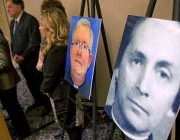 A photo of Rev. Robert Brennan, right, is displayed during a news conference in Philadelphia.
