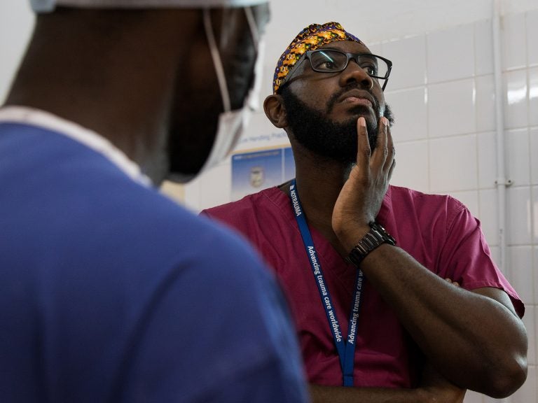 Orthopedic surgeon Kebba Marenah and his team get ready to perform knee surgery on a 14-year-old at the Edward Francis Small Teaching Hospital in Banjul, the capital of Gambia. The country struggles with a lack of access to sufficient pain medications. (Samantha Reinders for NPR)