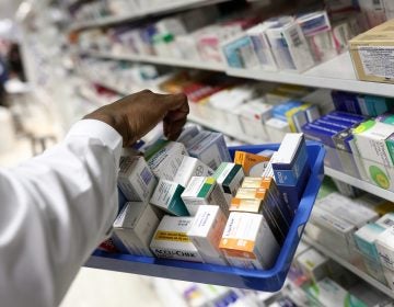 A pharmacist collects packets of boxed medication from the shelves of a pharmacy in London, U.K. A proposal announced by House Speaker Nancy Pelosi Thursday would allow the government to directly negotiate the price of 250 U.S. drugs, using what the drugs cost in Australia, Canada, France, Germany, Japan, and the United Kingdom as a baseline. (Bloomberg via Getty Images)