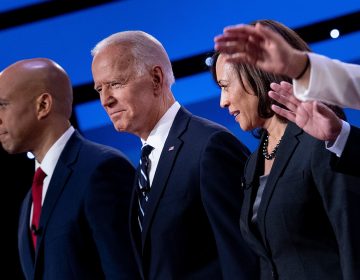 Democratic presidential hopefuls (from left): Sen. Cory Booker, D-N.J., former Vice President Joe Biden, and Sen. Kamala Harris, D-Calif., onstage before the July debate. (Brendan Smialowski/AFP/Getty Images)