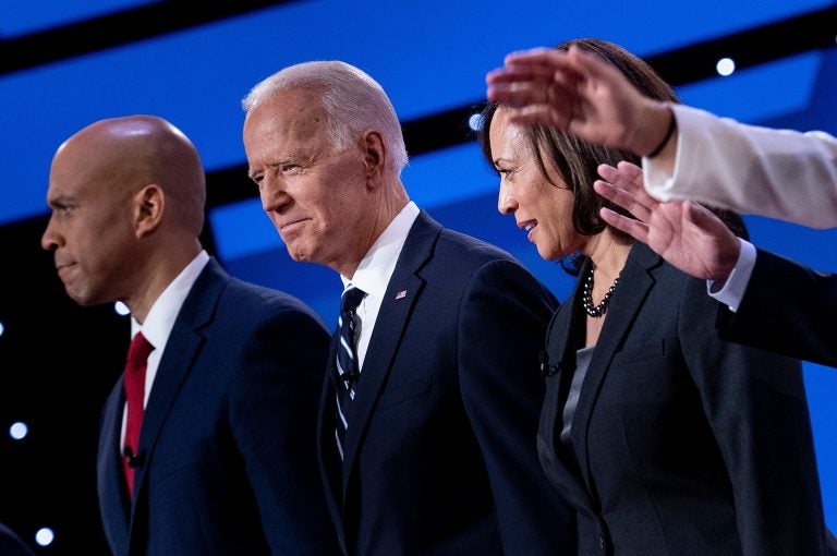 Democratic presidential hopefuls (from left): Sen. Cory Booker, D-N.J., former Vice President Joe Biden, and Sen. Kamala Harris, D-Calif., onstage before the July debate. (Brendan Smialowski/AFP/Getty Images)