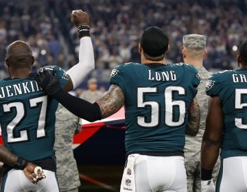 Eagles safety Malcolm Jenkins (left) raises a fist during the national anthem in 2017 as teammate Chris Long (right) places a hand on his shoulder in solidarity MATTHEW EMMONS / USA TODAY SPORTS
