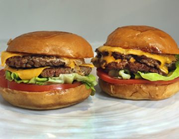 An Original Impossible Burger, left, and a Cali Burger, from Umami Burger, are shown in this photo in New York, Friday, May 3, 2019. A new era of meat alternatives is here, with Beyond Meat becoming the first vegan meat company to go public and Impossible Burger popping up on menus around the country. (AP Photo/Richard Drew)