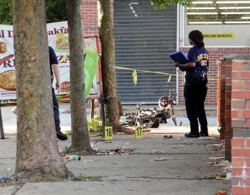 Police investigate a 2018 drive-by shooting in Germantown. The City’s Controller has found that a homicide reduces the values of a nearby homes. (Emma Lee/WHYY)