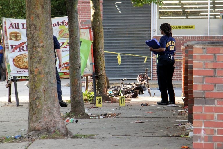 Police investigate a 2018 drive-by shooting in Germantown. The City’s Controller has found that a homicide reduces the values of a nearby homes. (Emma Lee/WHYY)