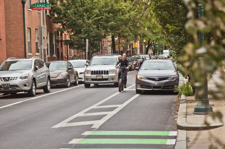 A cyclist rides down a bike lane in Philadelphia