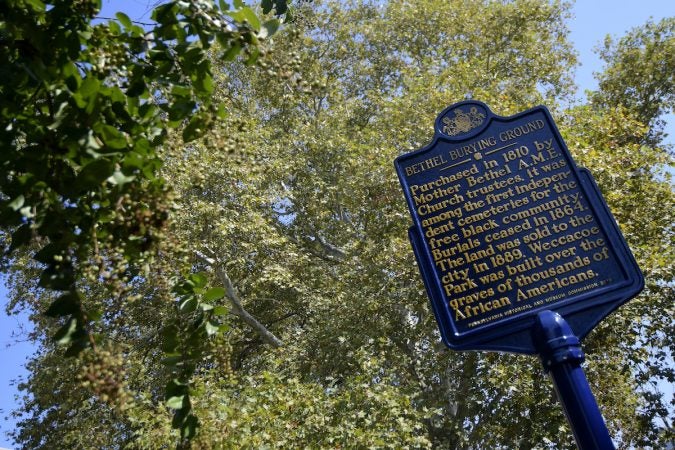 An official Pennsylvania historical marker is unveiled at the Bethel Burying Ground, located under the site of Weccacoe Playground, in Queen Village, on Tuesday. (Bastiaan Slabbers for WHYY)