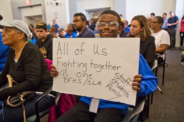 Maurice Boston, a freshman at Ben Franklin H.S., shows his support at a packed meeting discussing the closures of Ben Franklin and Science Leadership Academy high schools because of asbestos remediation at the school district building Monday morning. (Kimberly Paynter/WHYY)