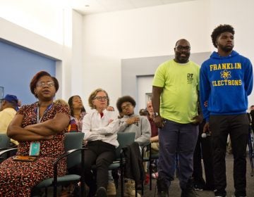 At the School District headquarters on  Monday morning, parents and students at a packed meeting discuss the closures of Ben Franklin and Science Leadership Academy high schools because of asbestos remediation. (Kimberly Paynter/WHYY)