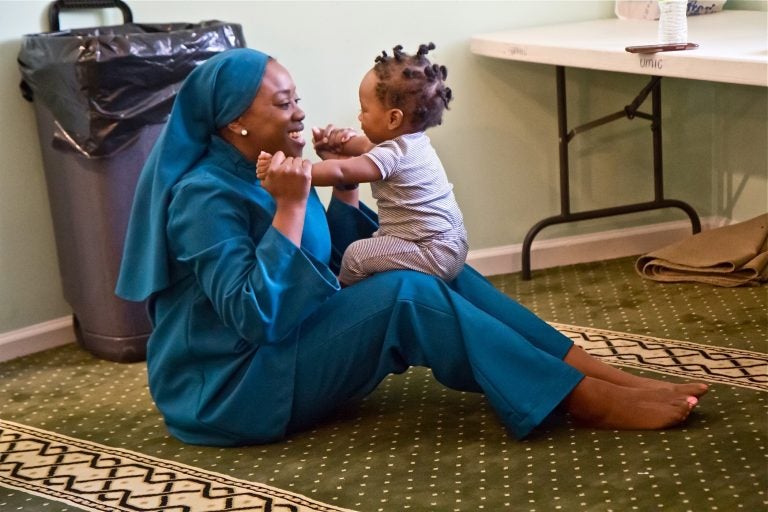 Tahirah Austin, who has sickle-cell disease, plays with Kinza, the son of a friend who also has the disease. (Kimberly Paynter/WHYY)