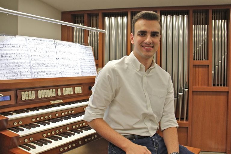 Adrian Binkley, an student at the Curtis Institute of Music in Philadelphia, has been surveying church pipe organs in churches outside Center City. (Emma Lee/WHYY)