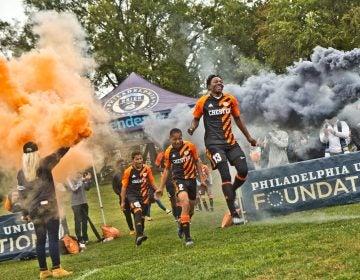 The Chester High School soccer team takes the field for their first home game in over 30 years. (Kimberly Paynter/WHYY)