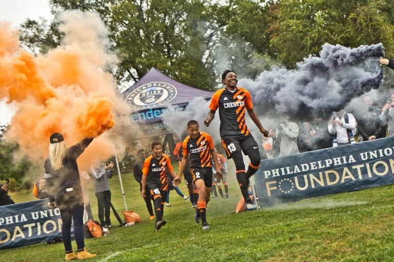 The Chester High School soccer team takes the field for their first home game in over 30 years. (Kimberly Paynter/WHYY)