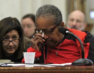 Belinda Thomspson, 69, wipes away tears as she tells how her brother tried to evict her from her mother's house. She spoke during a hearing on a City Council bill that would guarantee legal counsel for those facing eviction. (Emma Lee/WHYY)