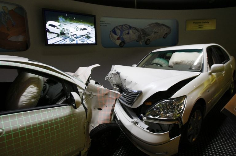 Crashed cars with airbags deployed are shown to visitors as part of the display of Toyota Motor Corp.'s safety performance standards, called 